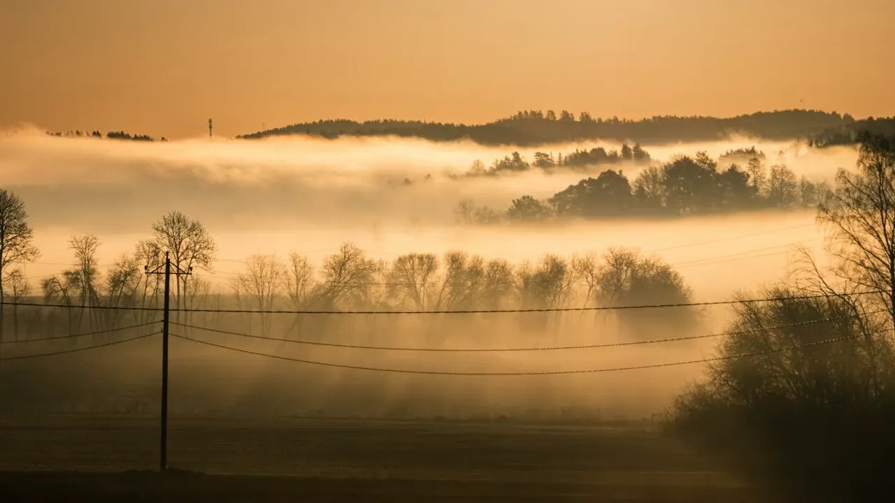 Slow view of morning fog over Kuusisto island in Finland, then Dolomite peaks in mist